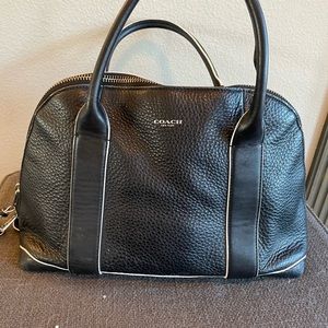 Coach black leather purse with white Piping and gold zipper.